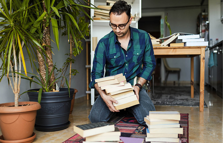 Man organizing books